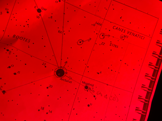 Printed star chart showing how to star-hop from Arcturus to M51 (the Whirlpool Galaxy), under red light.