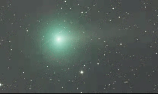 Greenish glow of Comet C/2025 R2 (SWAN) against a star field, photographed October 2025.